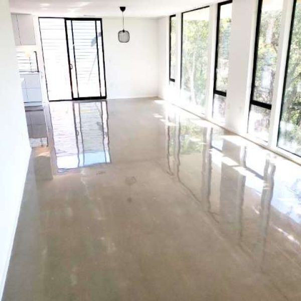 Polished concrete floors in a commercial building, offering a sleek and professional look that impresses clients and employees alike.