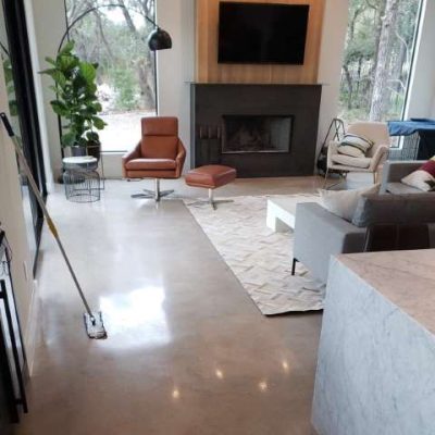 Distressed concrete floors in a residential home, adding rustic charm and character to the living space.