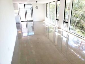 Polished concrete floors in a commercial building, offering a sleek and professional look that impresses clients and employees alike.