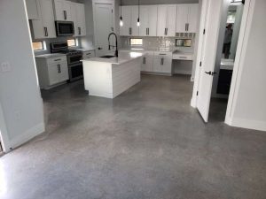 A stained concrete overlay in a kitchen, creating a unique and modern design that enhances the home's overall aesthetic.